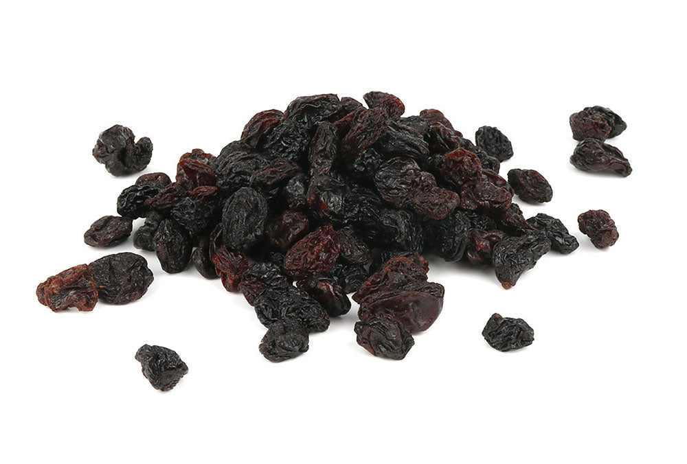 A Pile Of Black Jumbo Raisins On A White Background