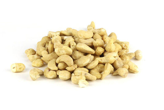 A pile of raw cashew nuts on a white background.