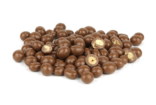 A Pile Of Milk Chocolate Peanuts On A White Background