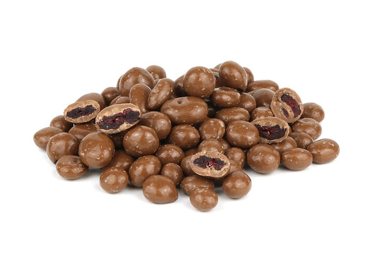 A Pile Of Milk Chocolate Cranberries On A White Background