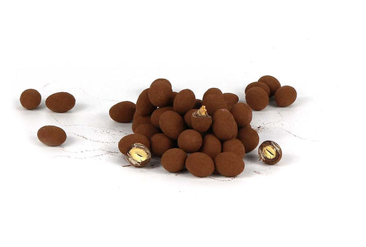 A Pile Of Cocoa Dusted Milk Chocolate Almonds On A White Backgrund