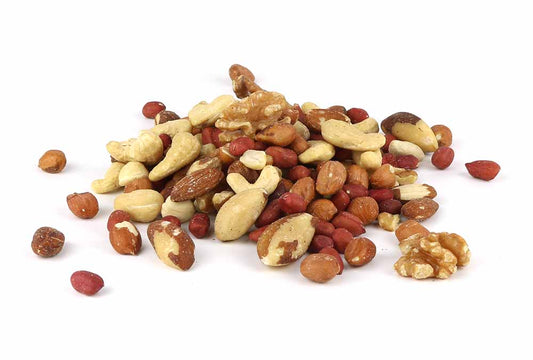 A heap of mixed nuts, including cashews, almonds, walnuts, peanuts, and possibly other varieties, is displayed against a plain white background. The nuts have different textures and colors, ranging from light cream to dark brown.