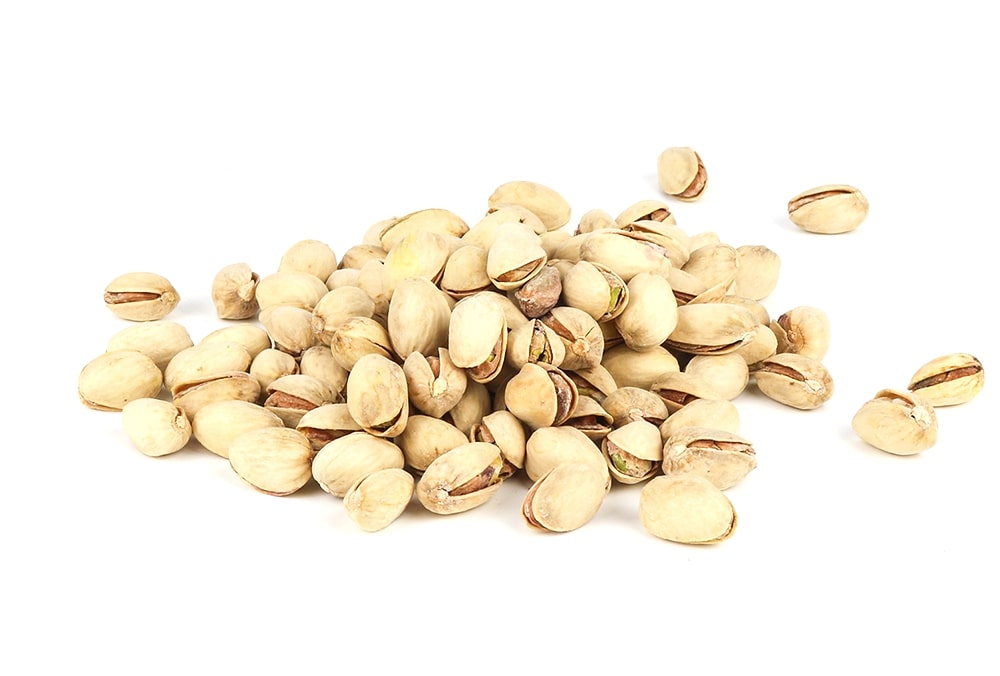 A Pile Of Roasted Pistachios On White Background