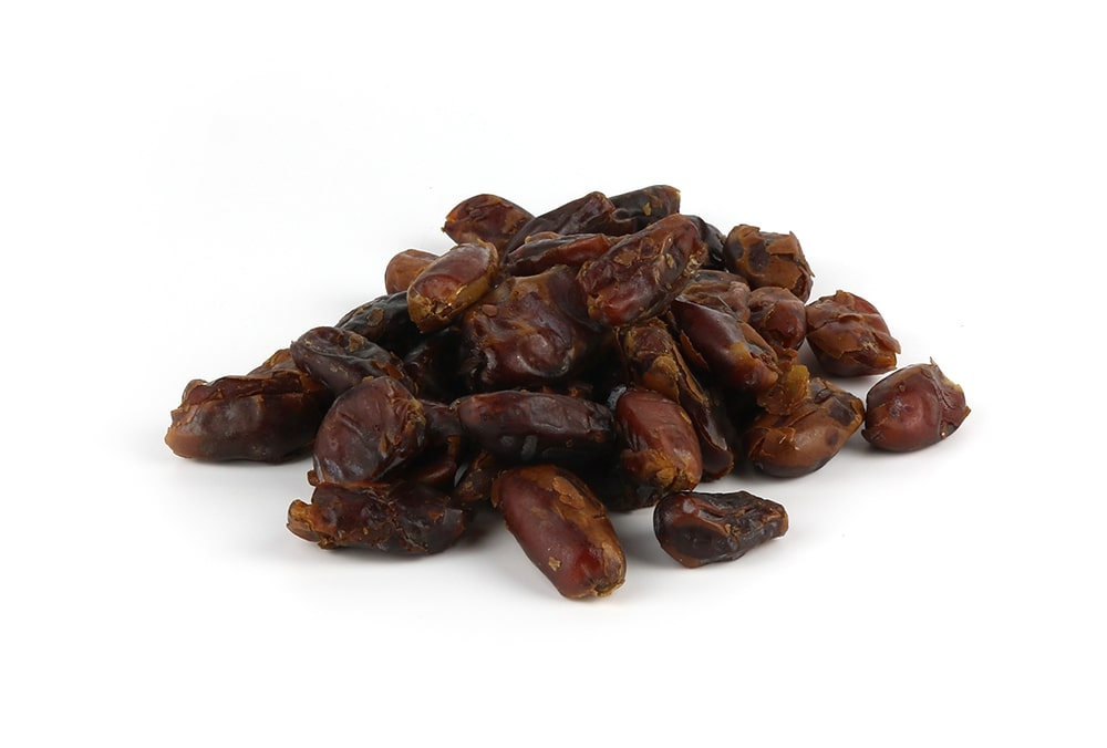 A Pile Of Pitted Dates On A White Background