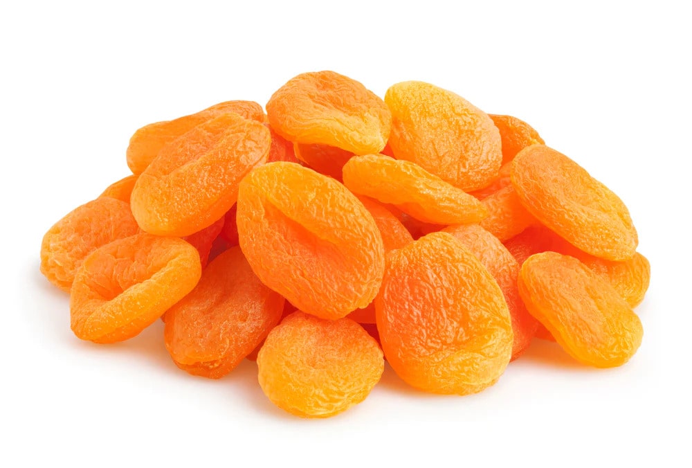 A Pile OF Dried Apricots On A White Background