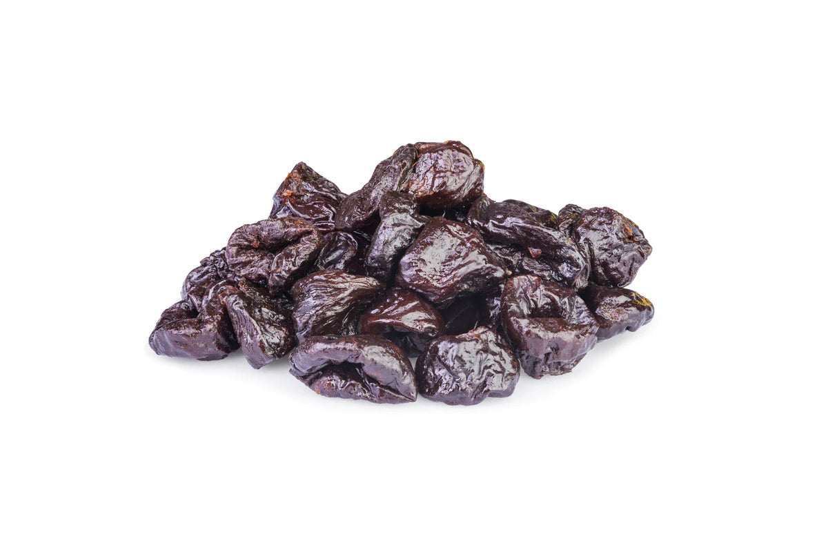 A Pile Of Pitted Prunes On A White Background