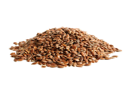 A Pile Of Brown Linseeds On A White Background