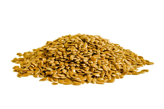 A Pile Of Golden Linseeds On A White Background