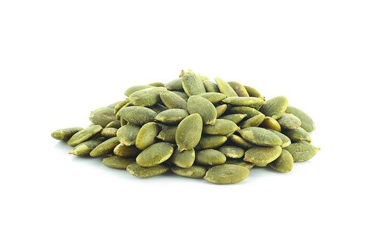 A Pile Of Pumpkin Seeds On A White Background